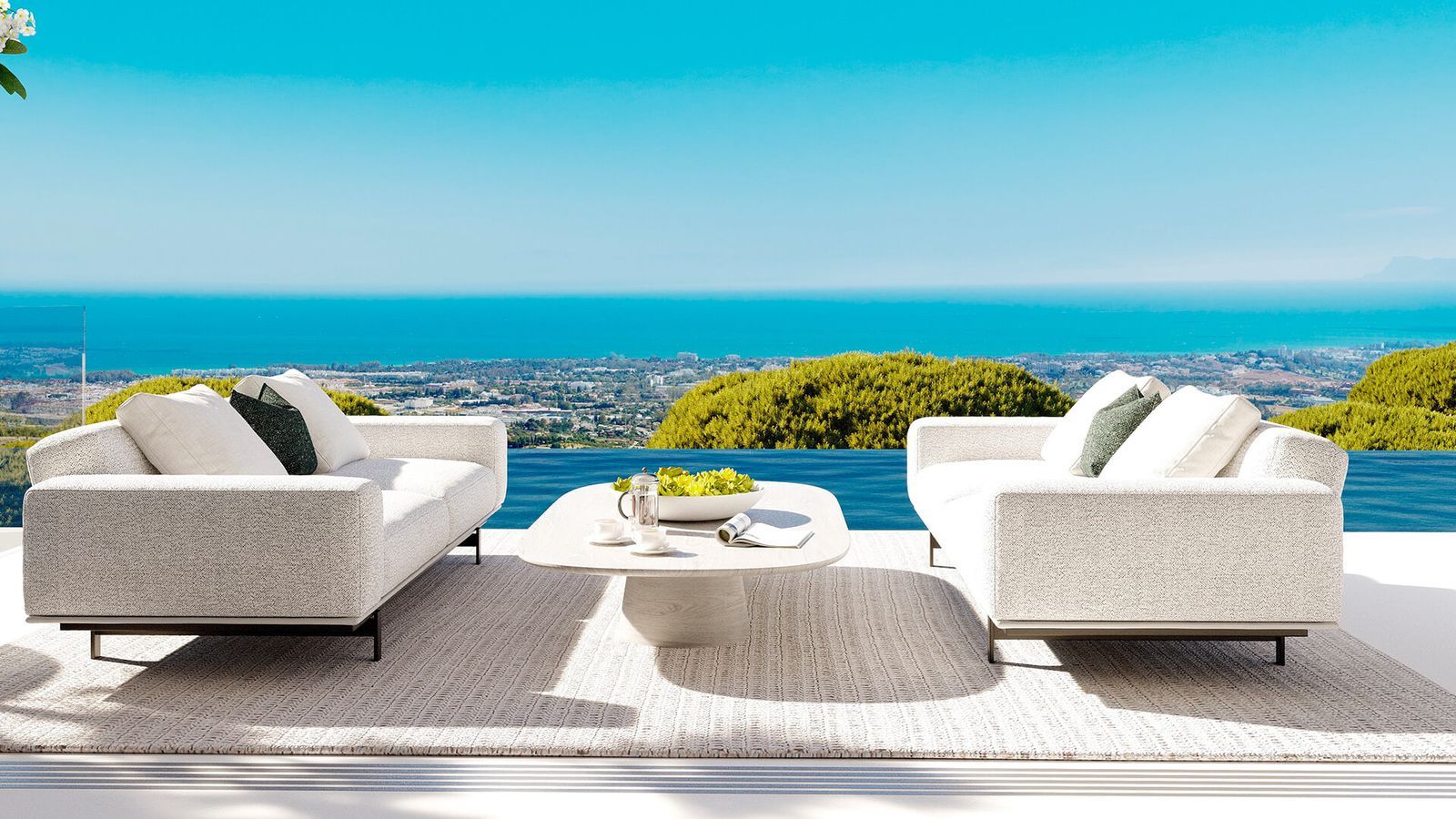 Terraza moderna con sofás cómodos y impresionantes vistas al mar en Vista Lago Residences.